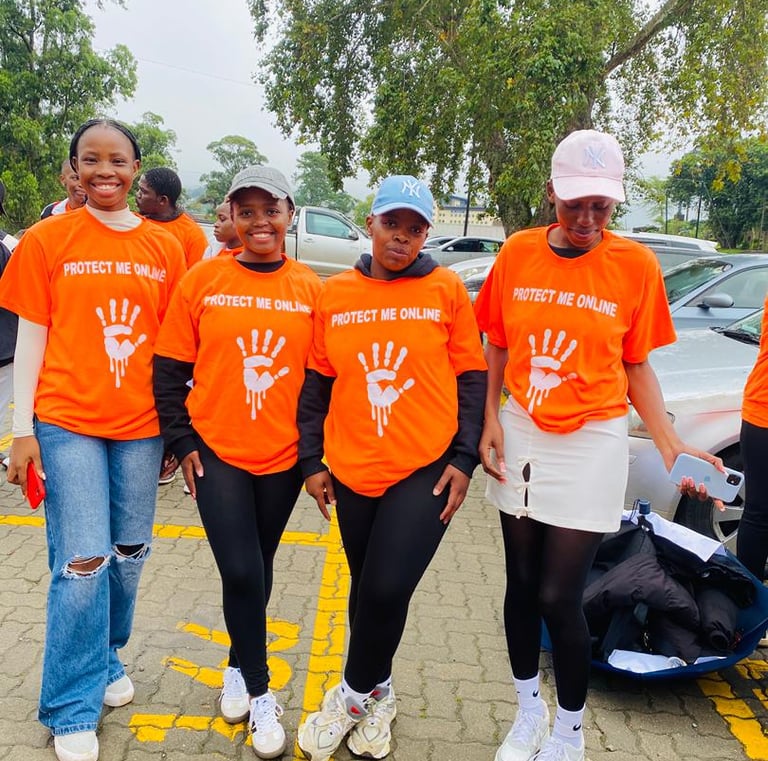 a group of people in orange shirts and jeans standing in a parking lot