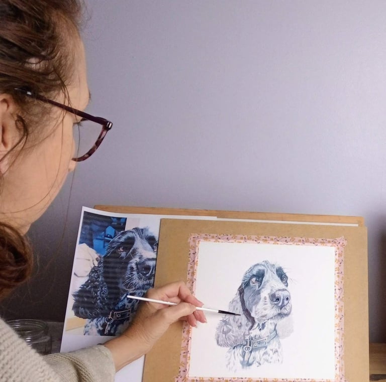Artist painting pet portrait in her studio