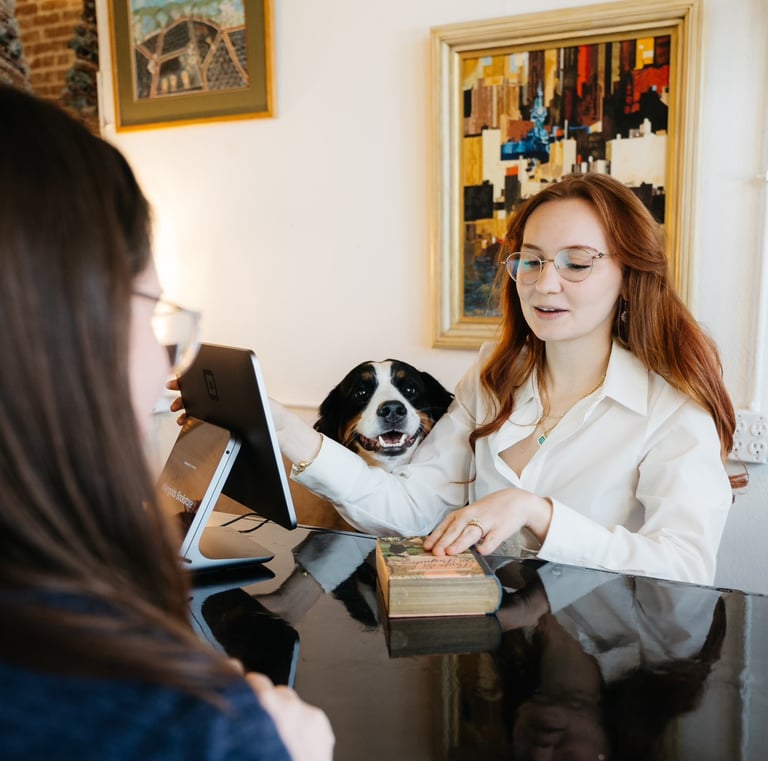 Kandelyne and her dog bonnie checking out a customer at Marigolds Bookstore