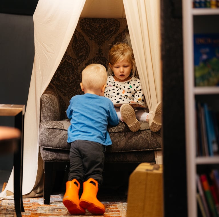 Two children reading a book in the Harry potter room at Marigolds Bookstore