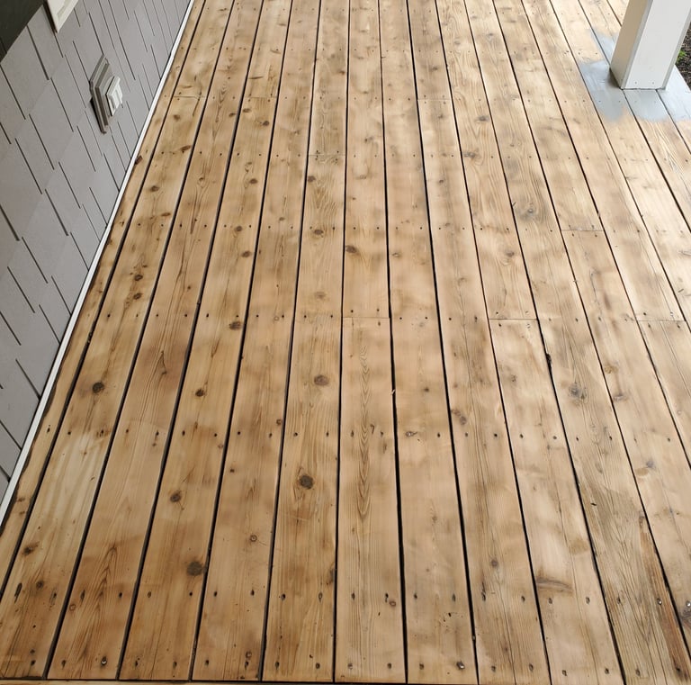 a wooden deck with a bench and a yellow umbrella