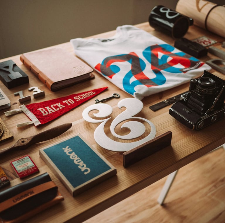 Flat lay of vintage stationery, a camera, and back to school supplies on a wooden desk.