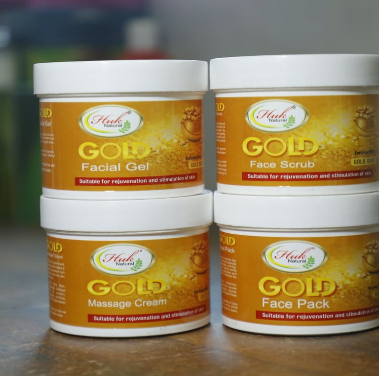 three jars of gold facial care products
