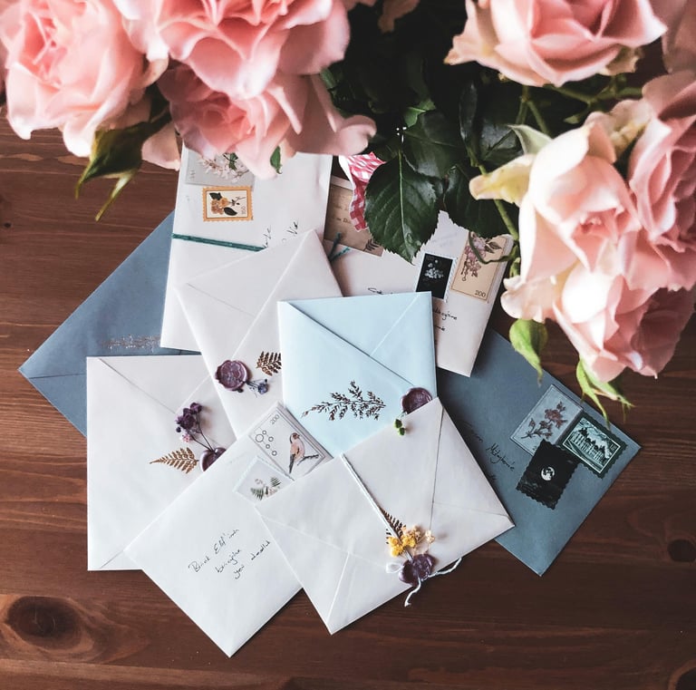 Kalligraphed handwritten love letter with quill pen on cream paper