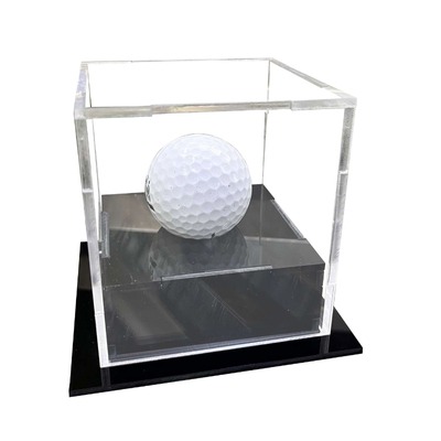 Small acrylic display box with a golf ball inside on a black base.