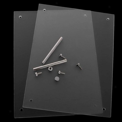 Two clear acrylic sheets and metal standoff parts arranged on a black surface.