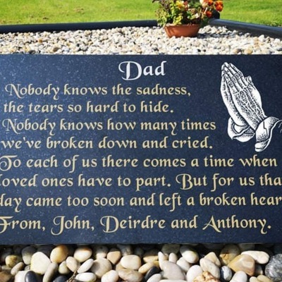 Memorial granite plaque for 'Dad' with engraved praying hands and a heartfelt message from family me