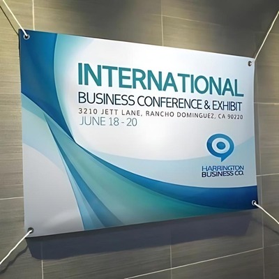 Printed banner for an international business conference with blue and green design elements.