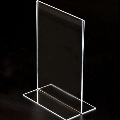 Clear T type acrylic display topper on a black background.