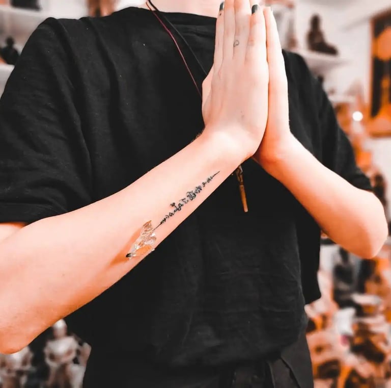 a person with a traditional thai tattoo sak yant on his arm