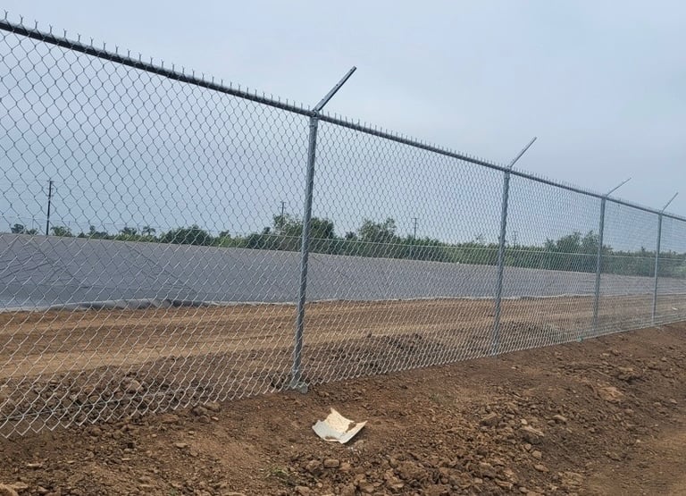 Chain link security fencing with barbed wire