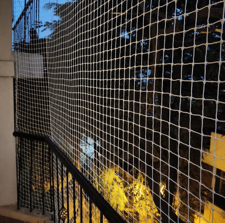 A balcony enclosed with fine mesh safety netting to keep children safe.