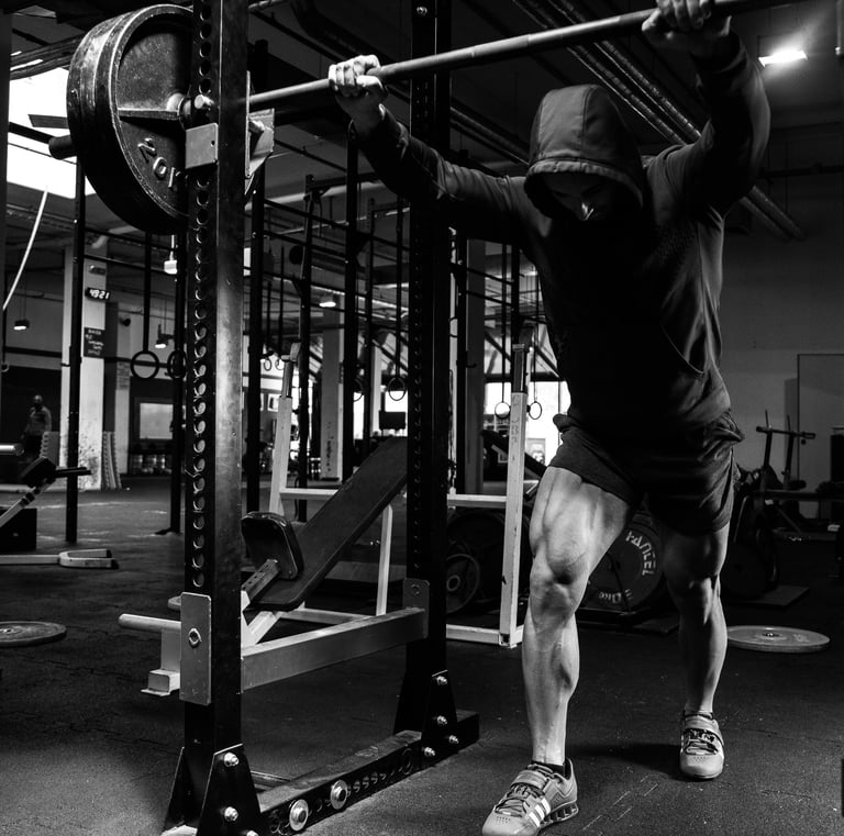 a man doing a pull up barbell in a gym