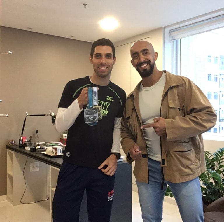 two men standing next to each other in a room