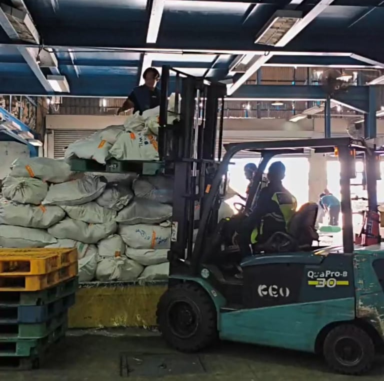 a forklift truck with a load of bags of bags of bags