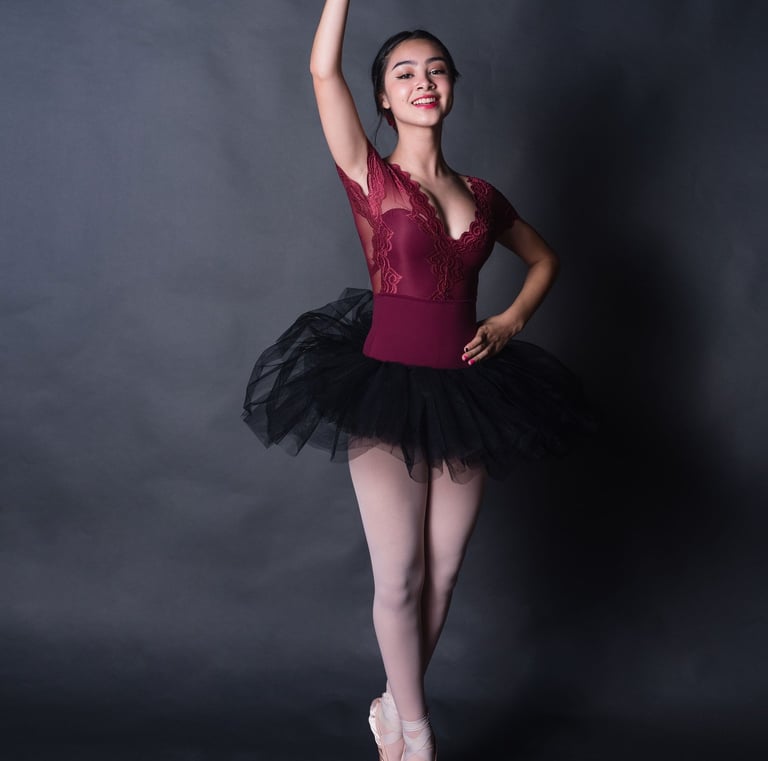 Teen ballerina in a red leotard and ballet shoes