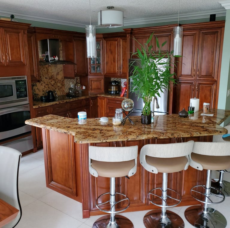 a kitchen with a large island and a bar stool