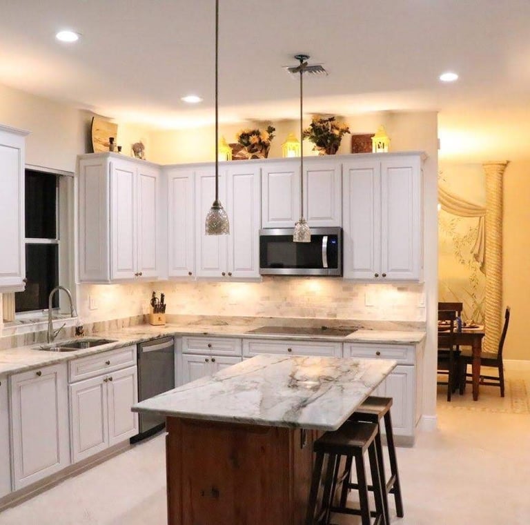 a kitchen with a large island and a table with chairs