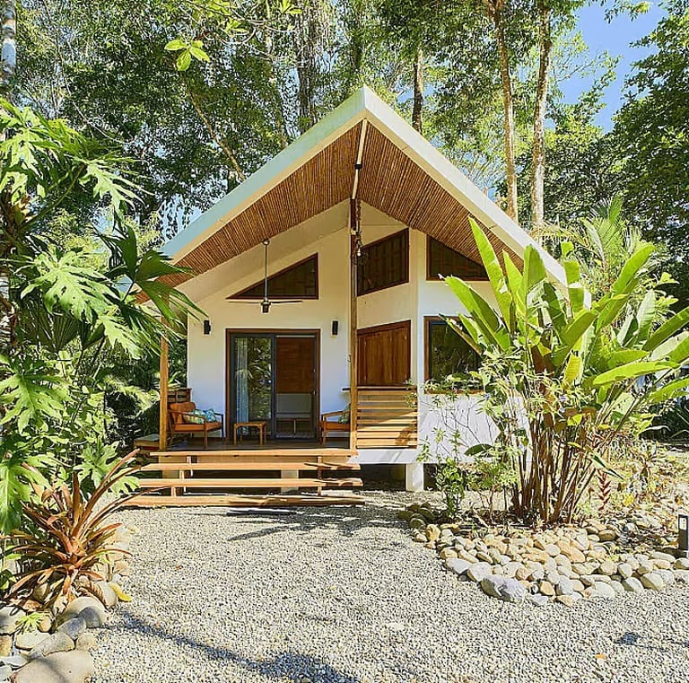 Private jungle cabin with wooden porch at Rose Temple Grove, a feminine retreat sanctuary in Costa R