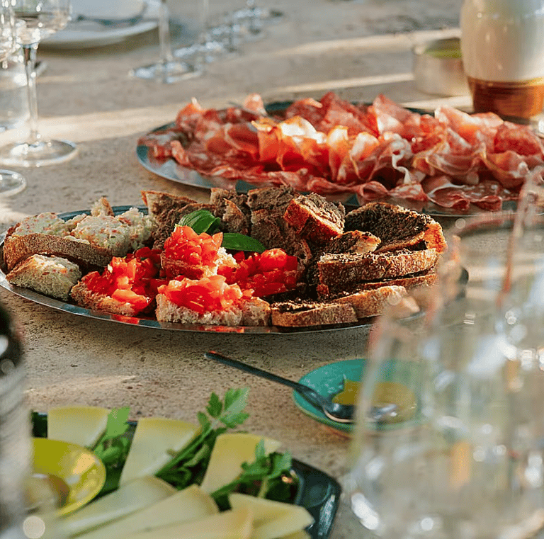 Traditional Italian antipasti with bruschetta, cheese and cured meats served during a soulful women’