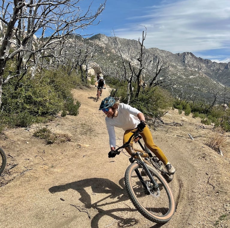a man riding a bike on a dirt road
