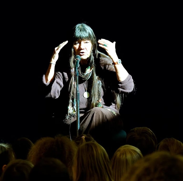 storyteller Dovie Thomason performs on stage
