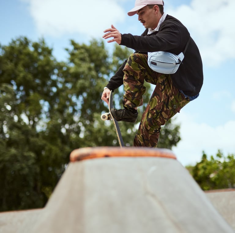 Fashion Photography - a man in camouflage pants and a baseball cap, skateboarding on a ramp