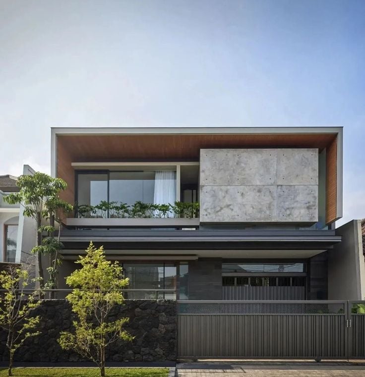 a modern house with a concrete facade and a concrete wall