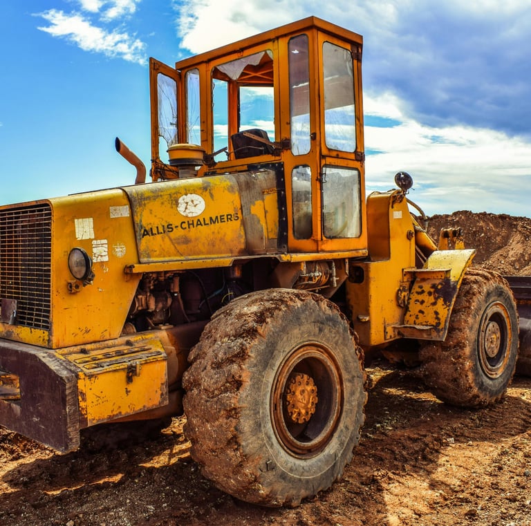 Demolition works-TLB carring rubble from an old building to the dumping site in spring-field, durban
