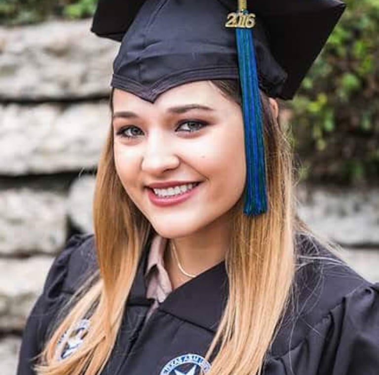 a woman in a graduation cap and gown
