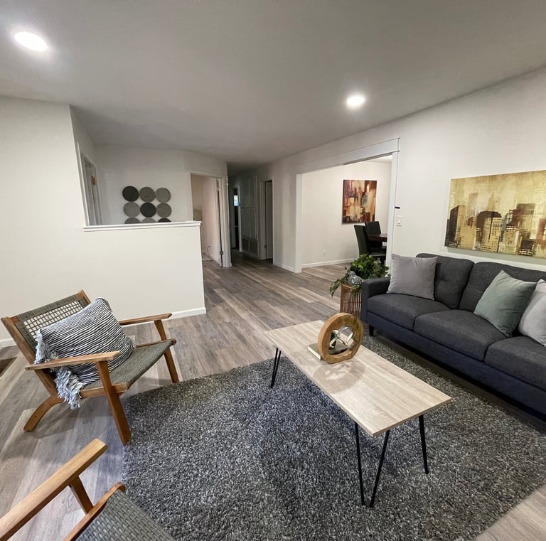 home remodelliving room with white painted walls, refinished light colored wood floors 