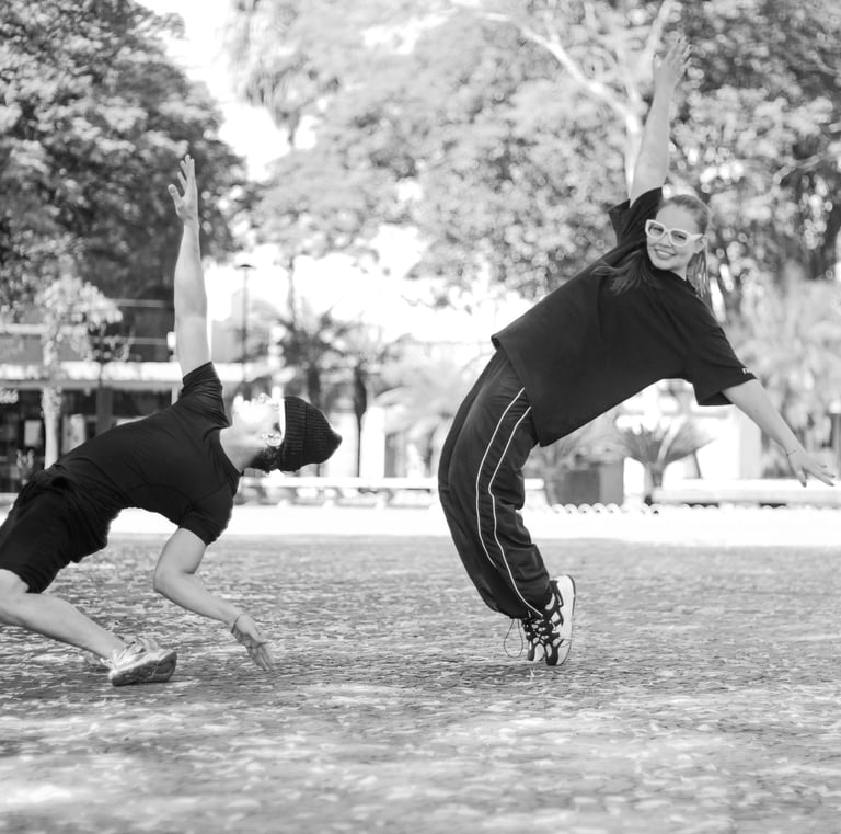 a man and a woman playing baseball in a park