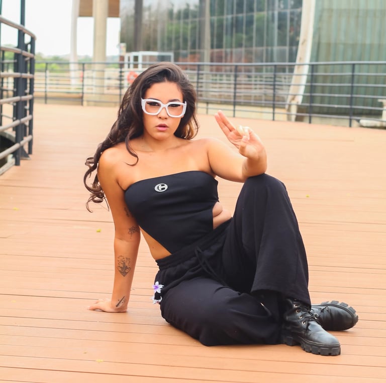 a woman in a black dress and sunglasses