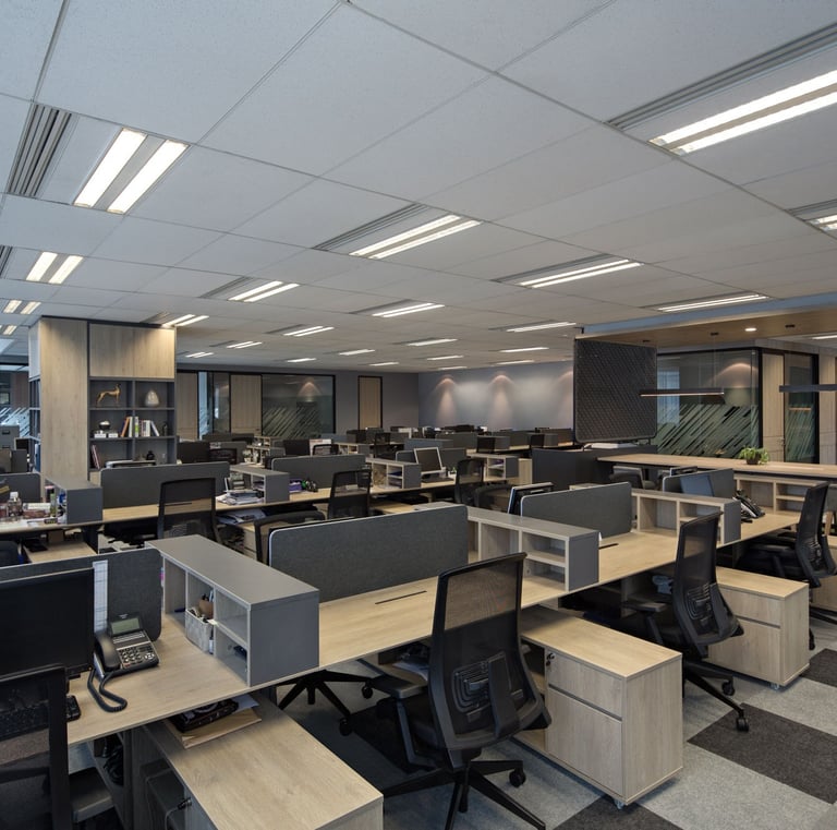 a large open office with a lot of desks and chairs