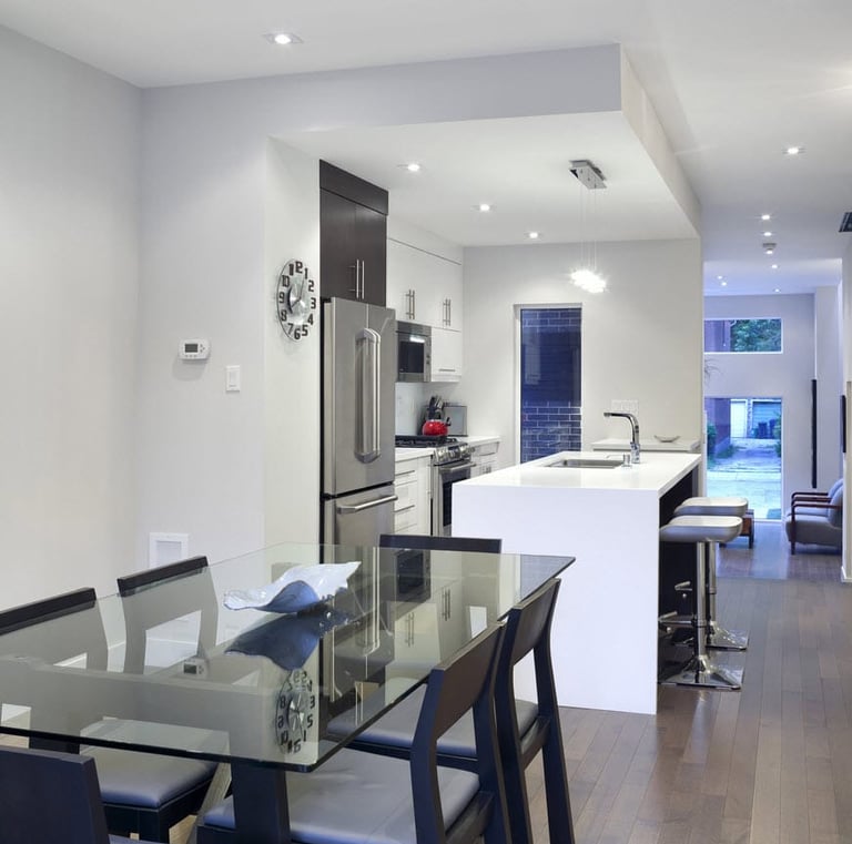 a kitchen with a table and chairs and a glass table