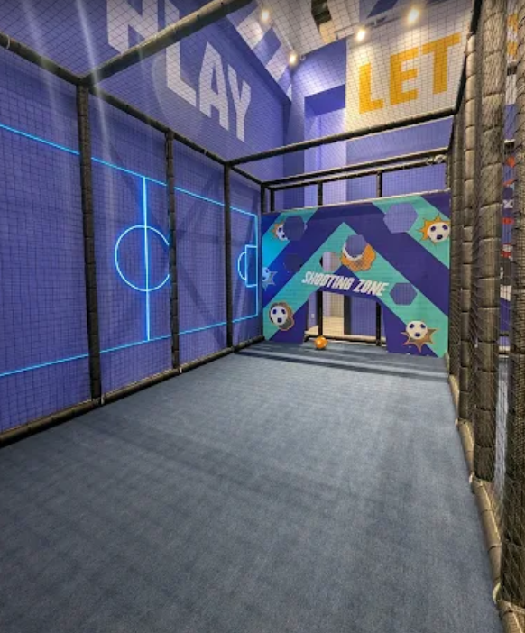 a soccer field with a goalie net and a goalie in playground