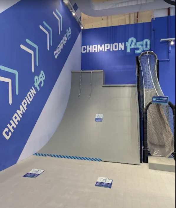 a playground is riding down a ramp at the skate park