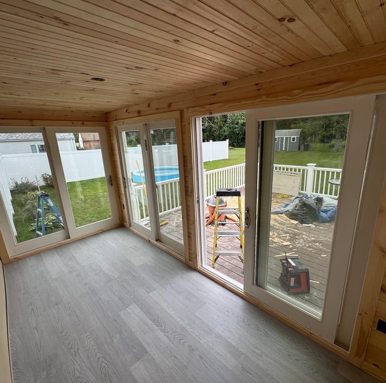 a room with a sliding glass door and a pool