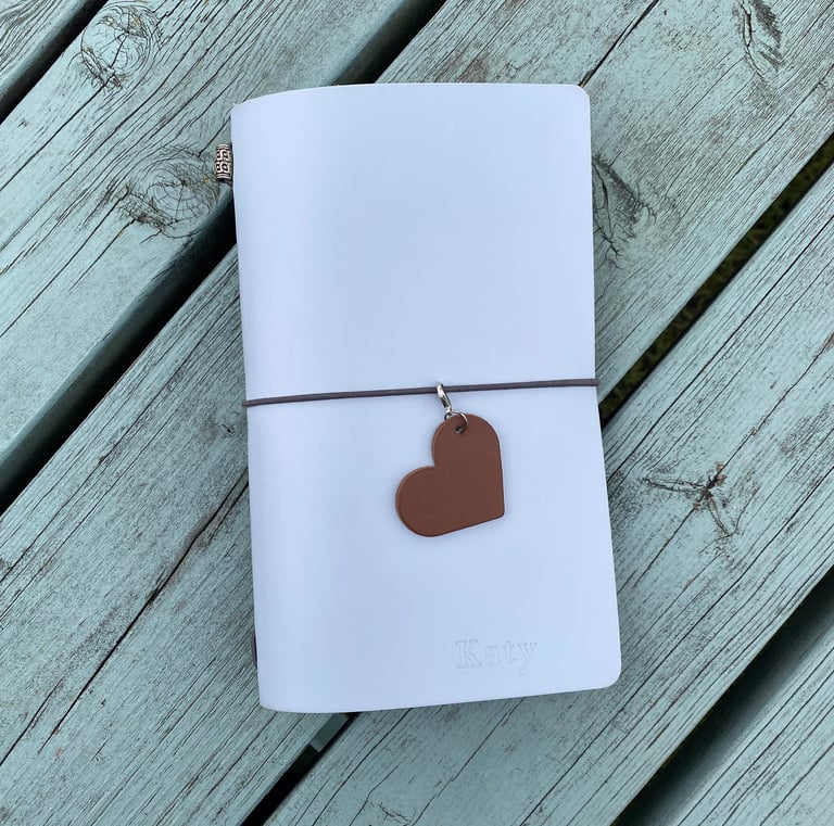a traveller style journal with a heart shaped leather journal