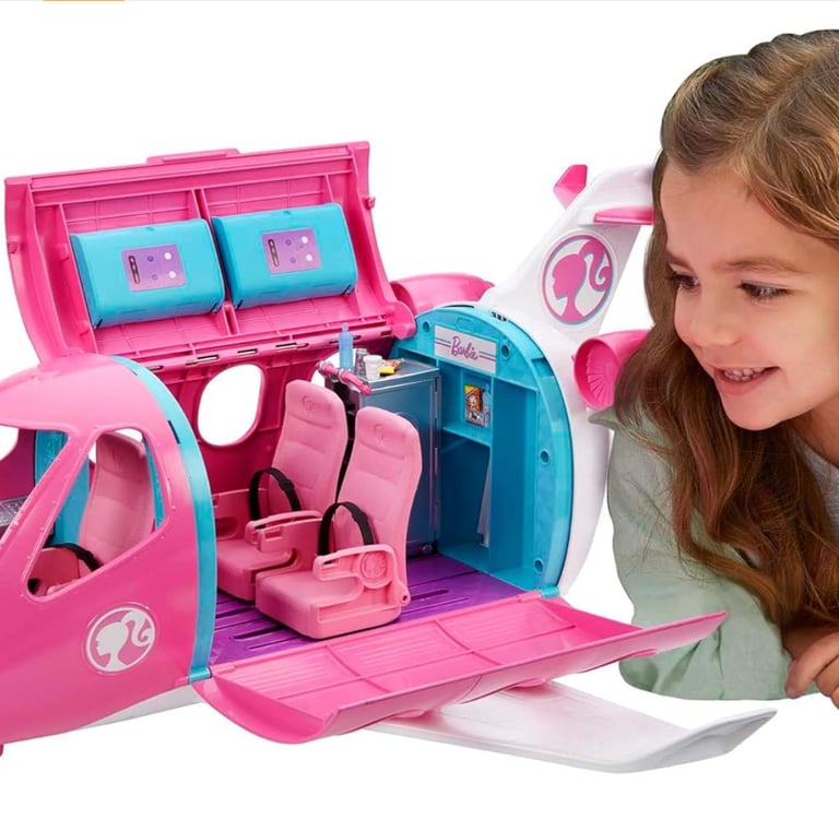 a girl is playing with a pink toy airplane
