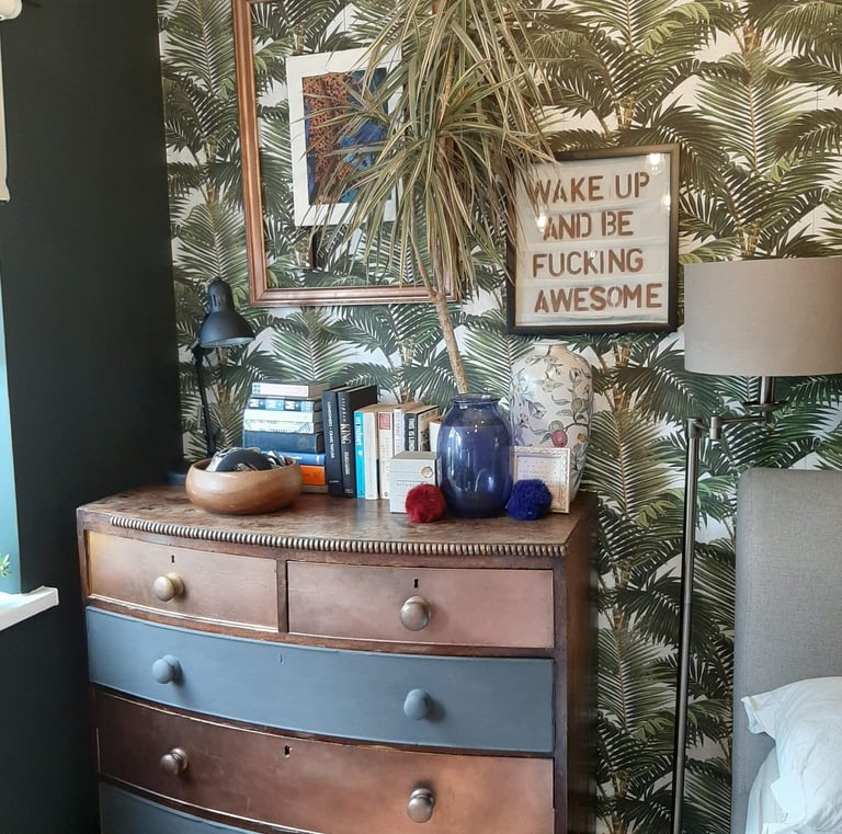 a dresser with wall art and accessories