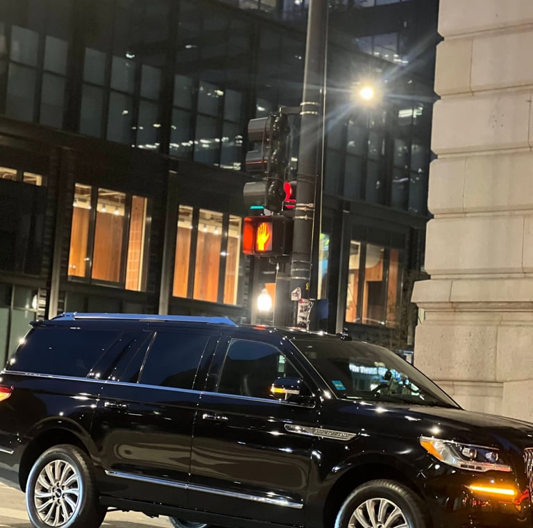 “Black Lincoln Navigator SUV providing Chicago black car service in downtown at night.”