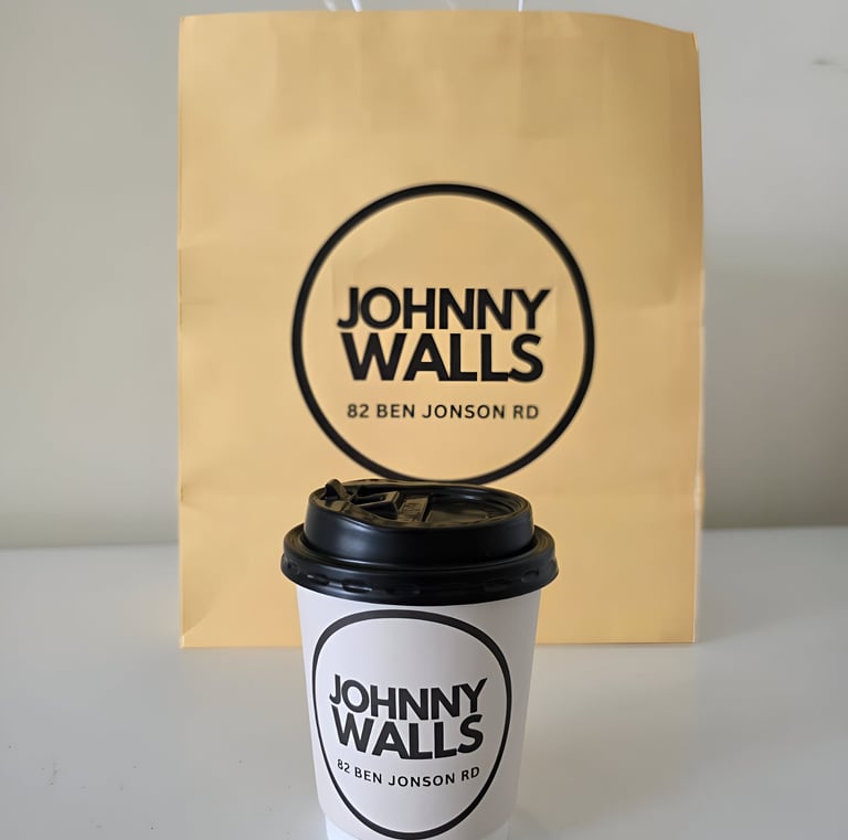 a coffee cup with a paper bag on it