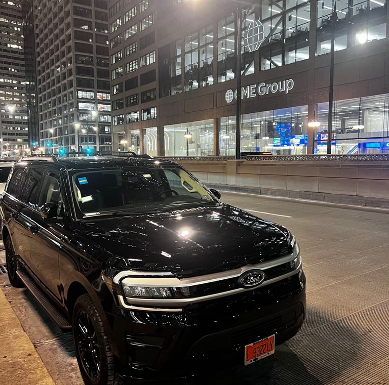 “Black Ford Expedition used for Chicago black car service parked downtown at night.”
