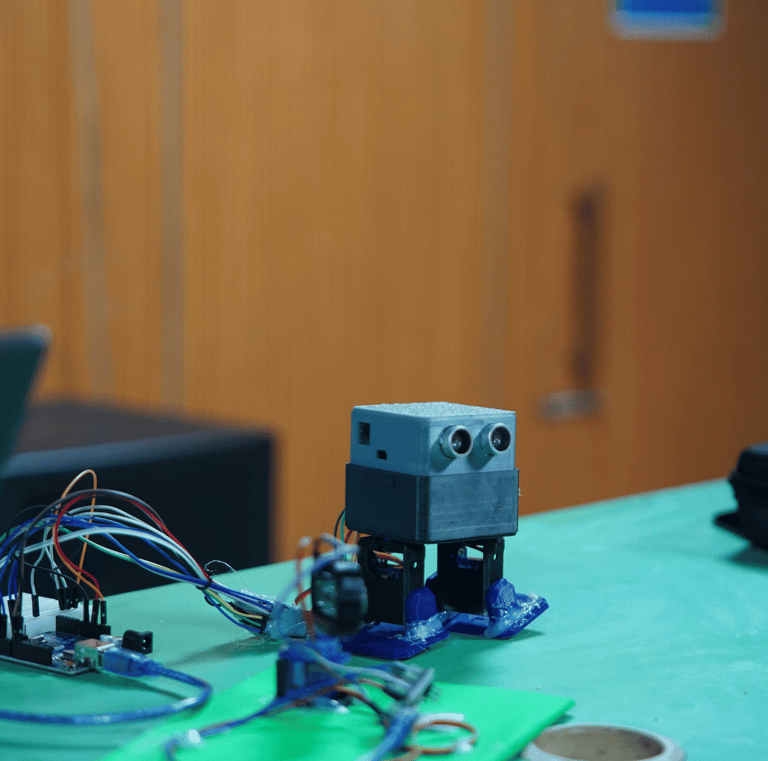 a robot robot with a laptop on a table