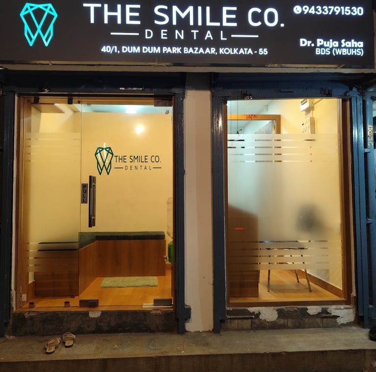 The Smile Co. Dental clinic storefront in Dum Dum Park, Kolkata, featuring a modern glass entrance.