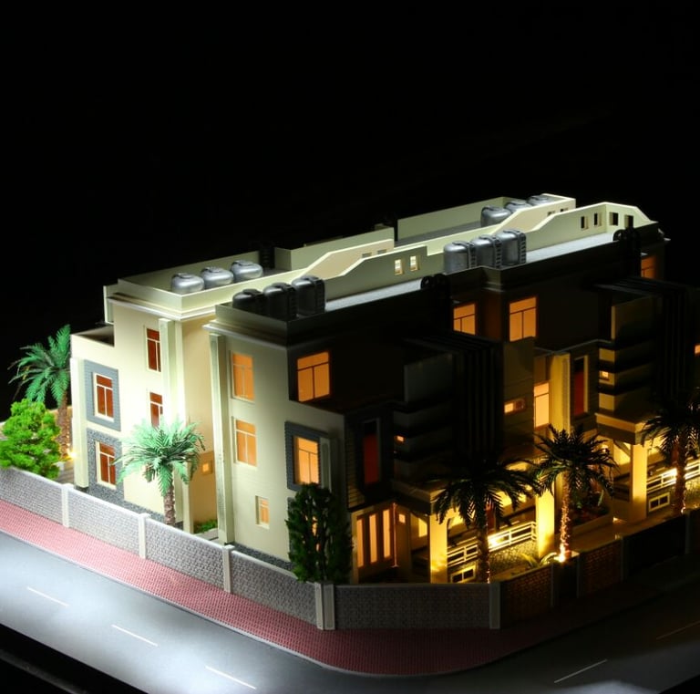 Detailed architectural model of a modern multi-story villa with interior lighting and palm trees