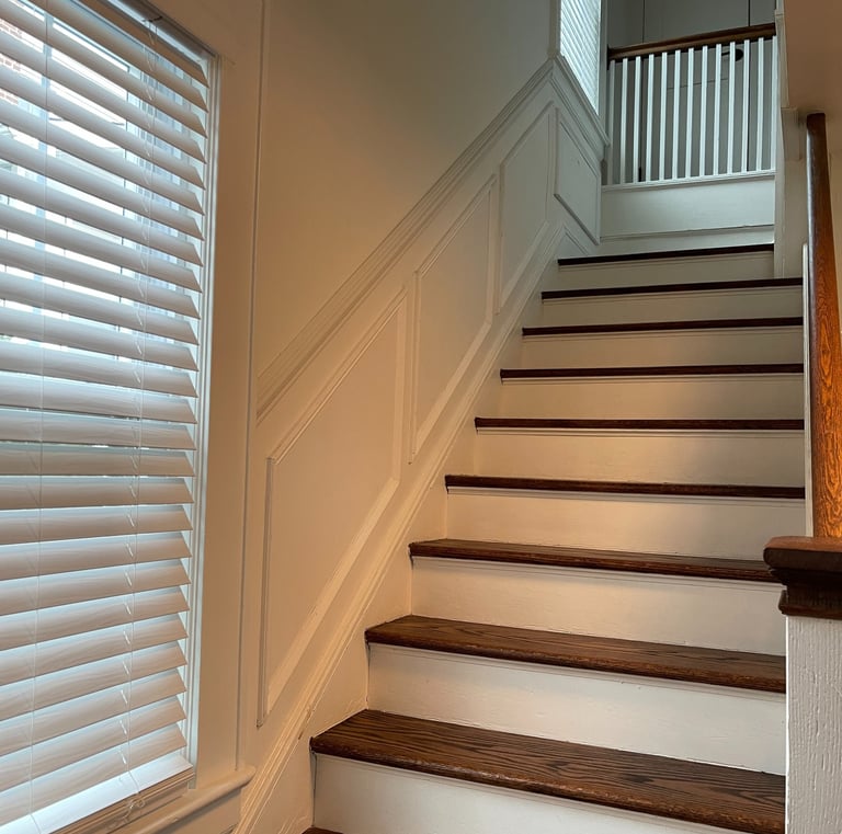 White staircase wall panels and wainscoting in a Monmouth County home