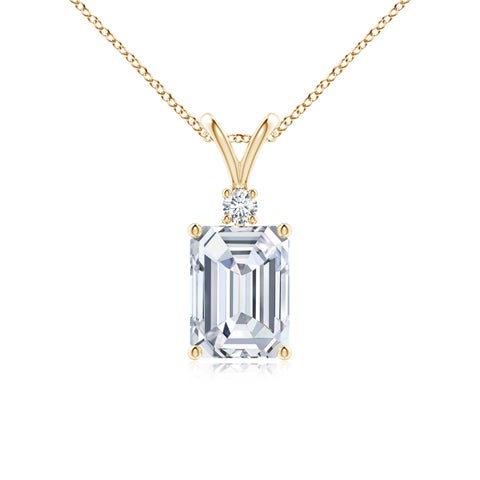 Emerald cut diamond pendant necklace in 14k yellow gold with round accent stone.