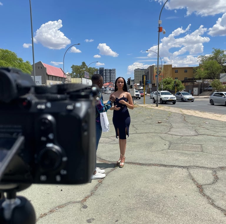 Shooting a video of a woman in a black dress